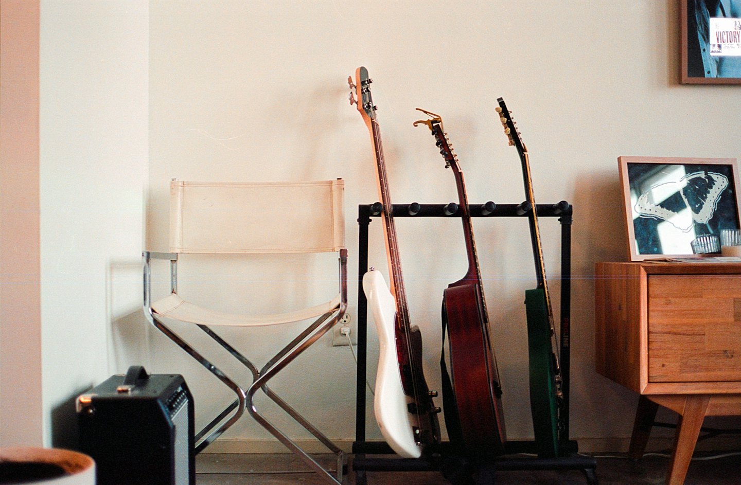 Musical instruments on a stand next to a director's chair.